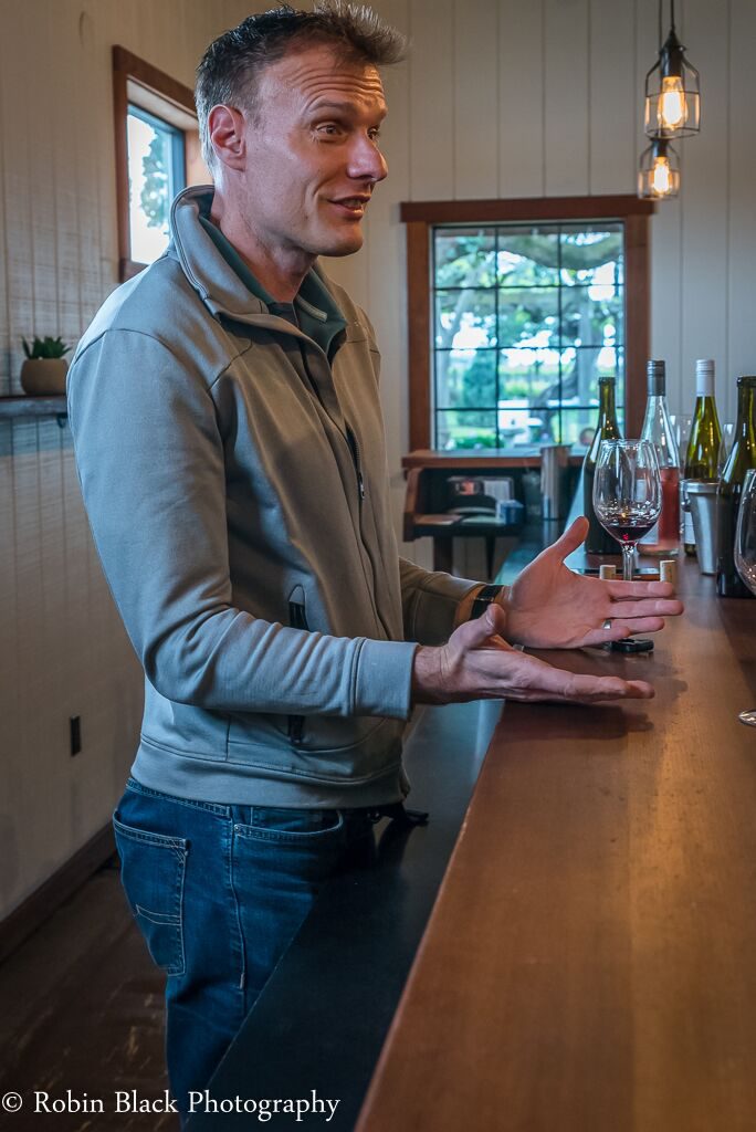 Niggli behind the bar in the tasting room, where he speaks passionately about the wines he makes.